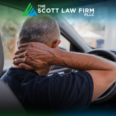 After a car accident in Vancouver, WA, a man with whiplash holds his neck