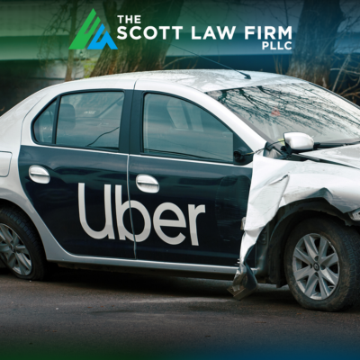 An Uber vehicle with damage to its front end in the aftermath of a car accident
