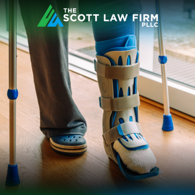 A construction worker injured on the job wearing a medical boot and walking on crutches