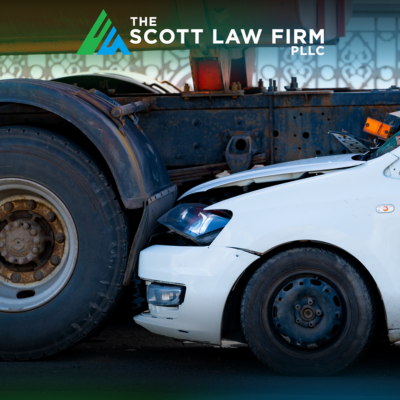 The front end of a white car stuck under a truck in a Vancouver underride accident