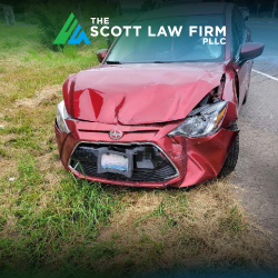 Red car with a damaged front end after a Vancouver, WA car accident 