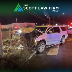 A white vehicle with a smashed front end after an intersection accident